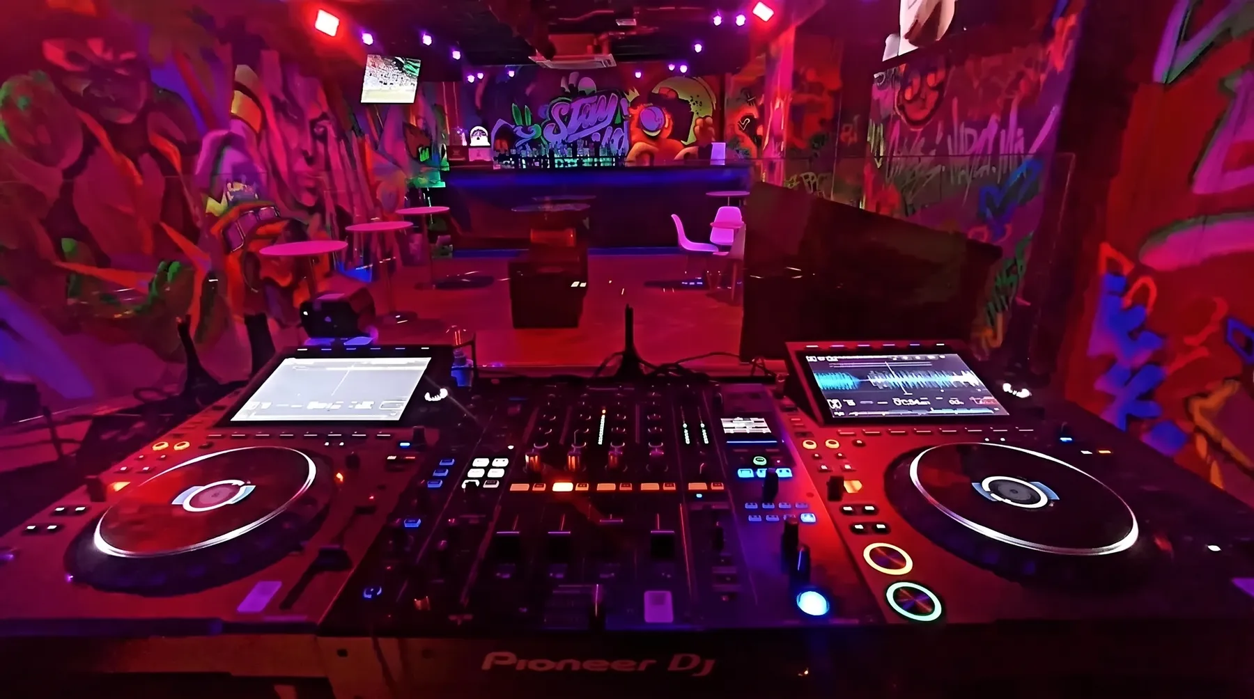 Pioneer DJ decks facing the graffiti bar